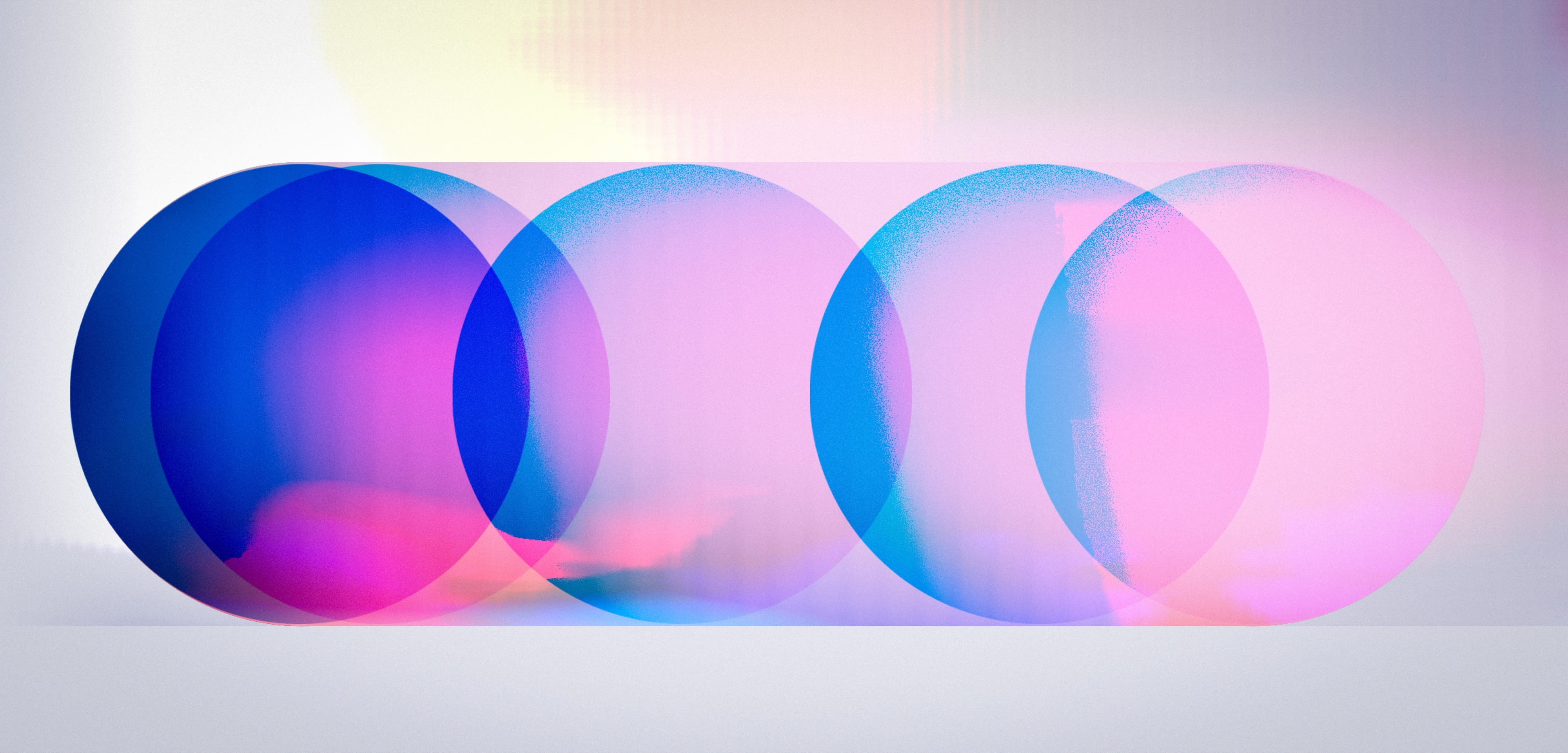 A sequence of translucent cyan, blue and pink circles forming a lozenge