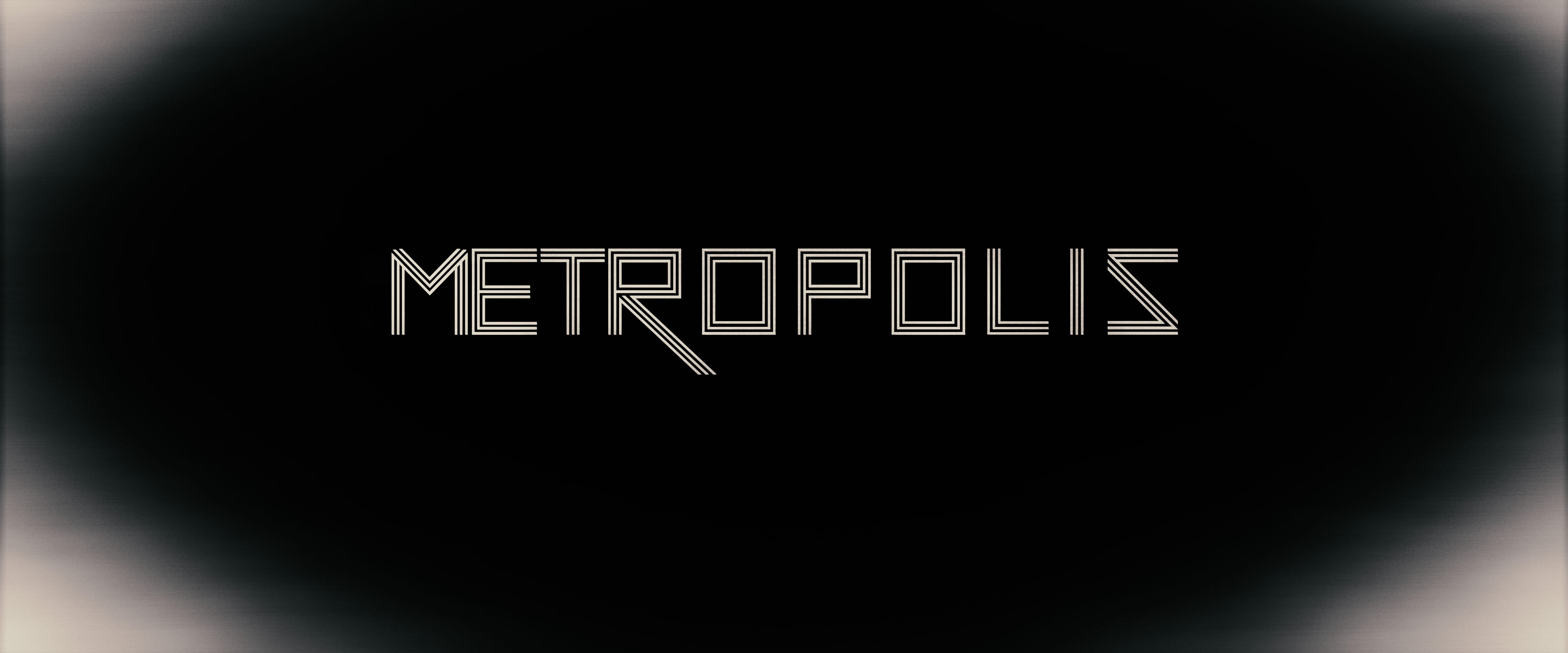 METROPOLIS title emerging from a monochrome atmospheric field