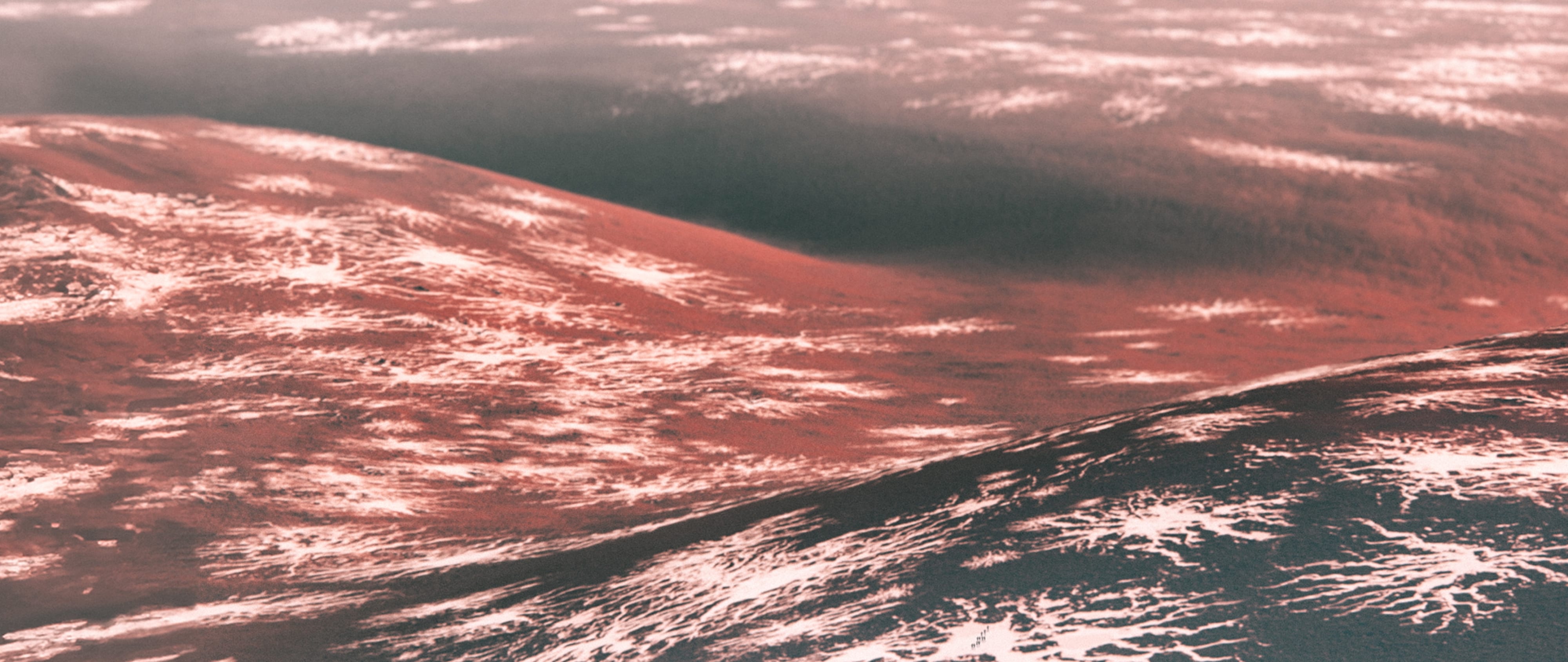 Layered pink and black Martian terrain extending into the distance