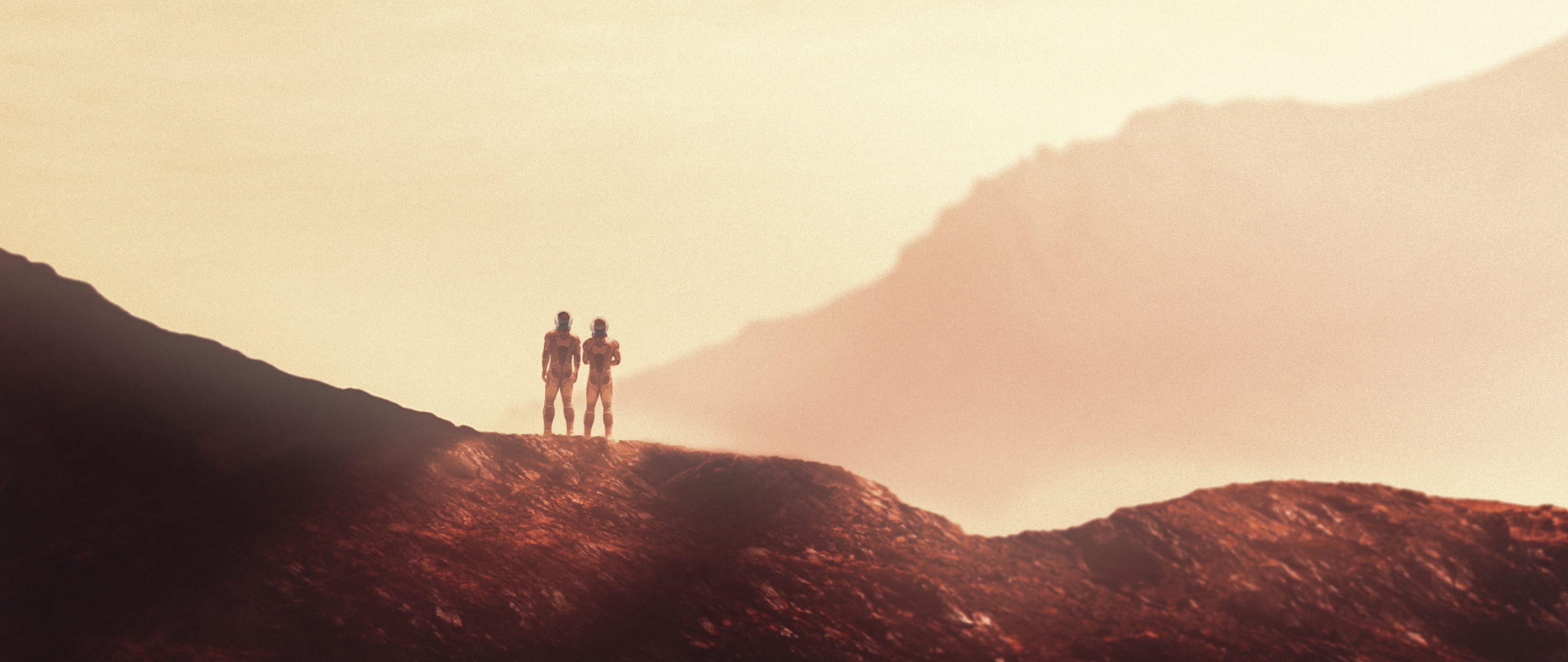 Two explorers standing together on a Martian ridge in pale atmospheric light