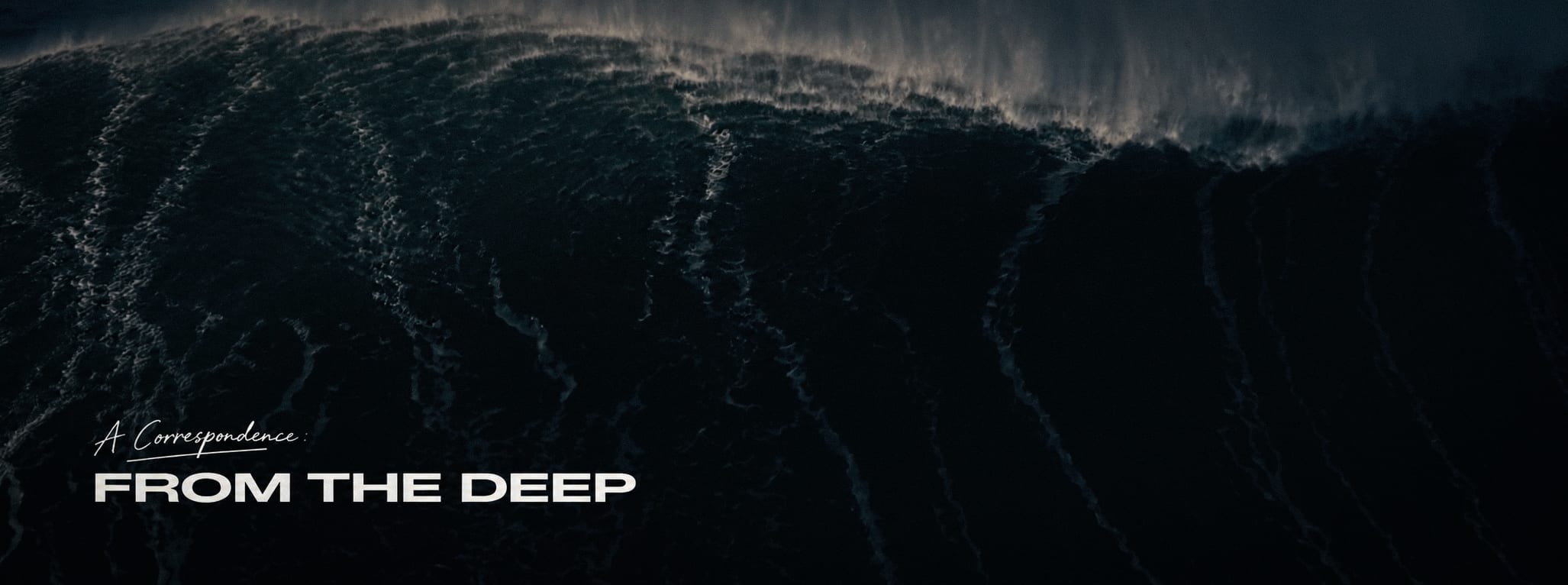 Small A Correspondence: From the Deep title mark held quietly at the left of a dark ocean wave