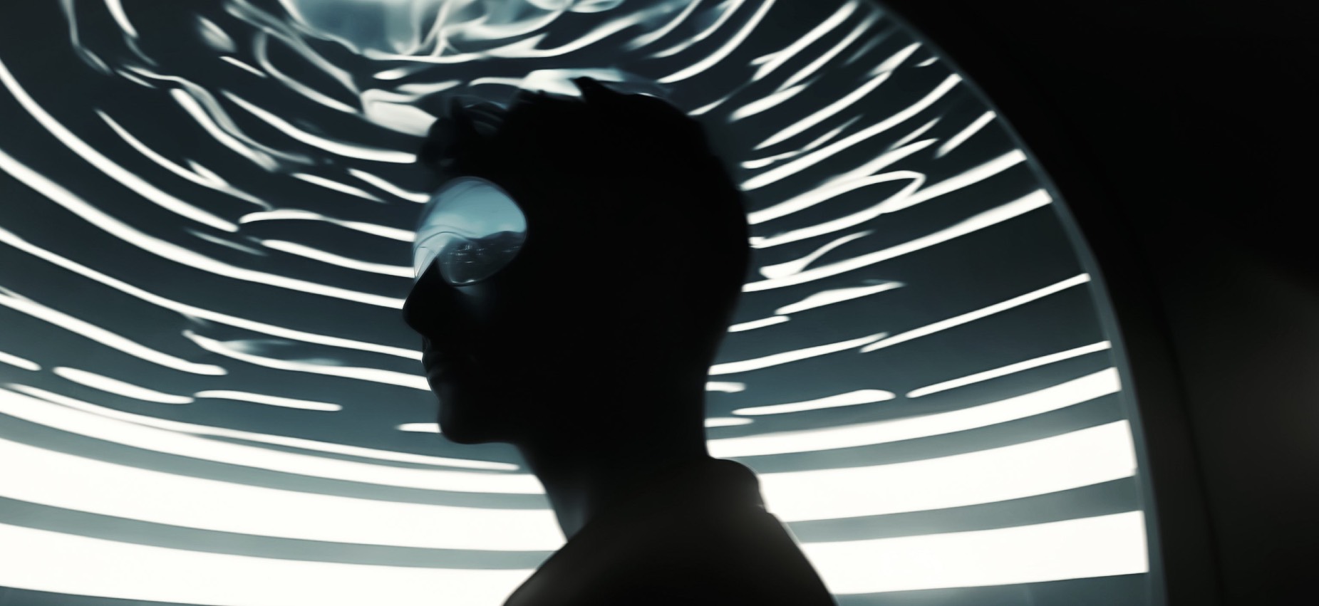 Silhouetted profile against a luminous radial field