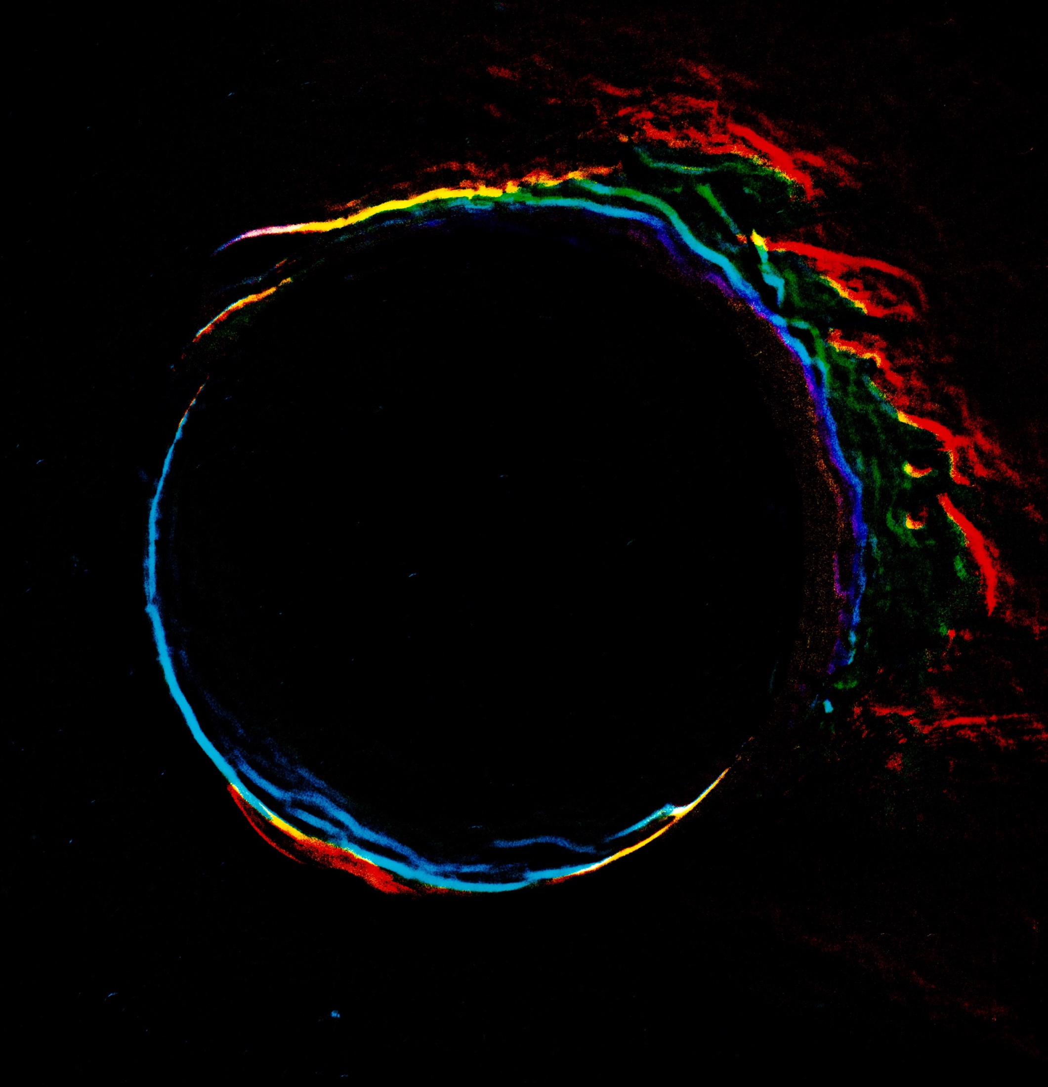 Close chromatic study of a portal edge shifting through cyan, green, red and yellow
