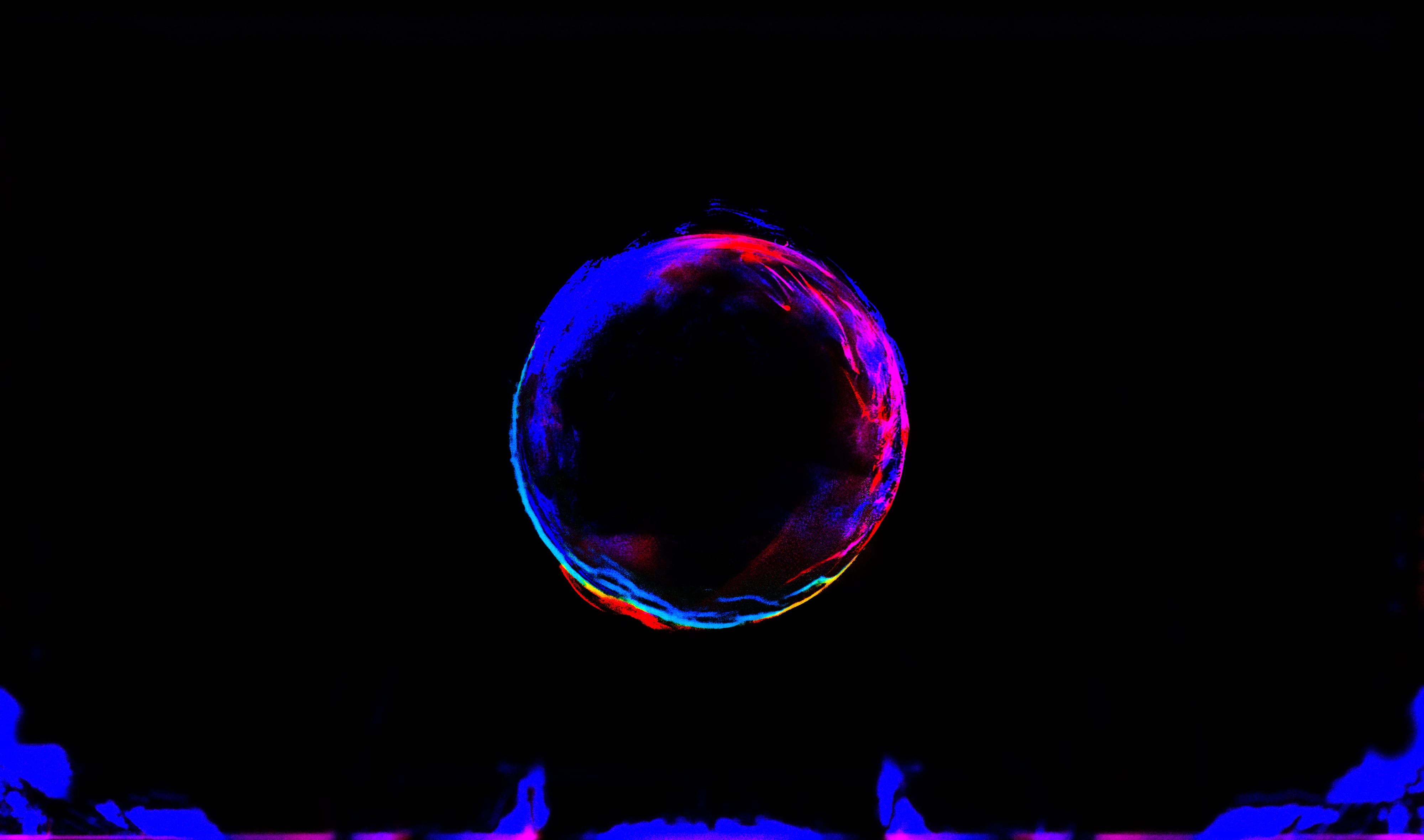 A red and blue luminous orb suspended above small human silhouettes